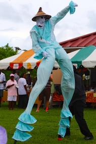 A moko jumbies entertains the crowd at the World Food Day celebration. A moko jumbies entertains the crowd at the World Food Day celebration.